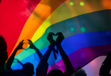 Pride rainbow flag with people silouetted