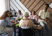 baby boomer and multigenerational group sitting around a work table