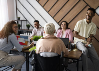 baby boomer and multigenerational group sitting around a work table