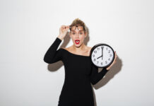 business woman holding clock